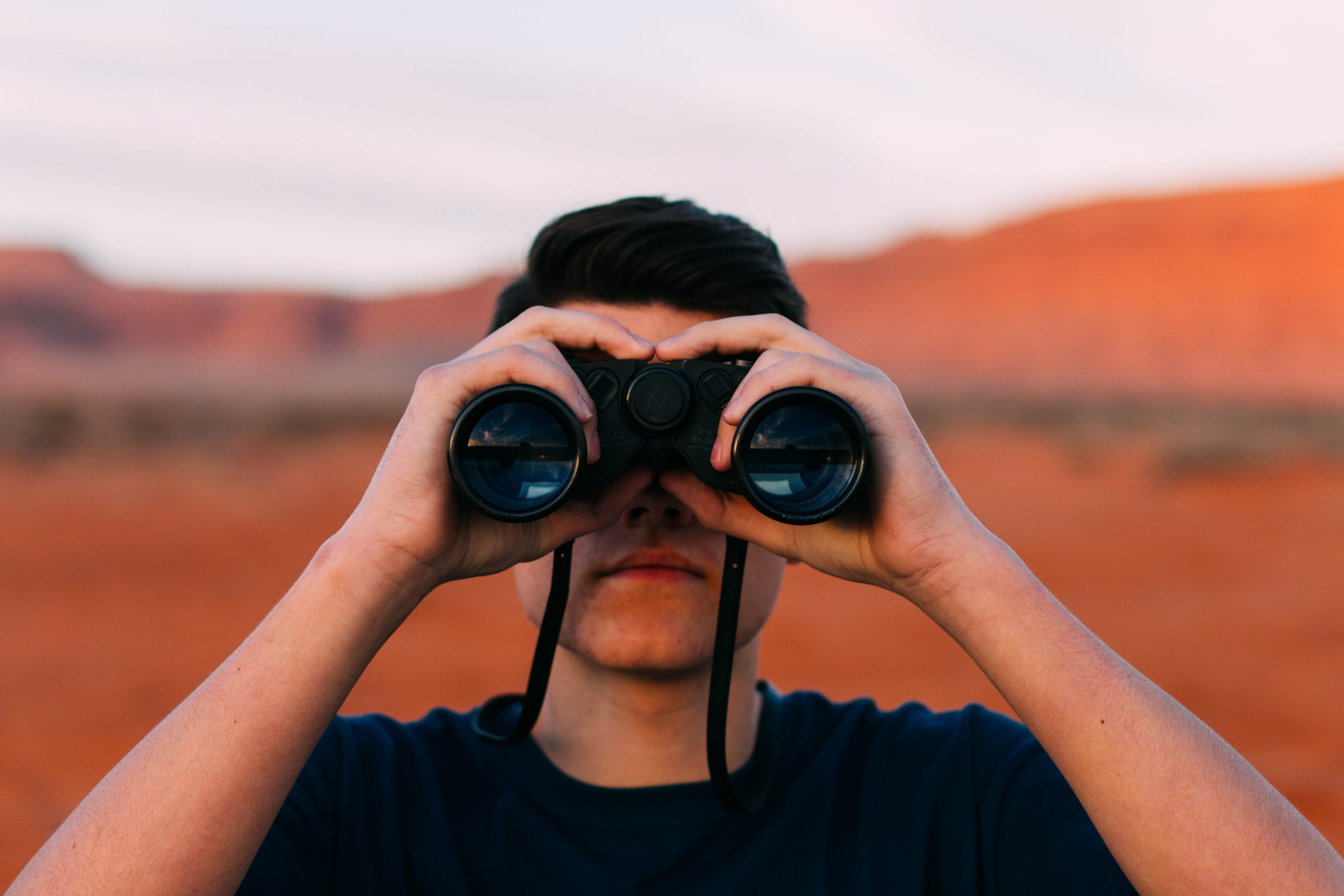 Man Looking Through Binoculars